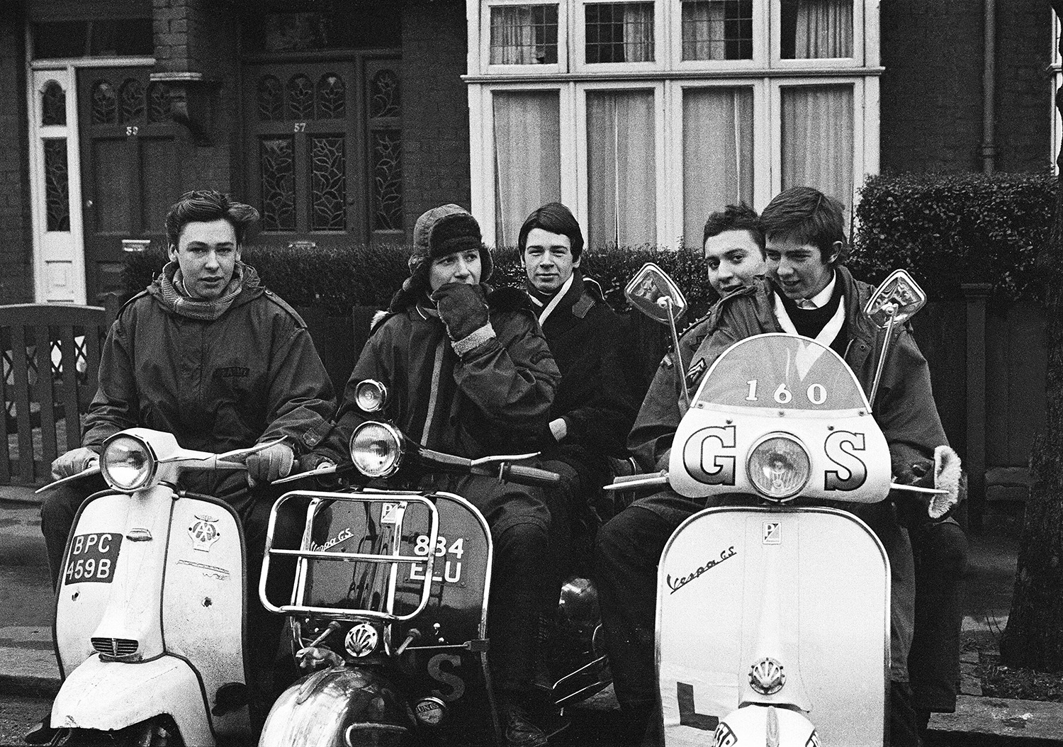 Teenage mods, modernists in parkas on their Vespa scooters during swinging sixties, London, 1964 by Peter Francis