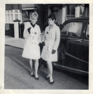 Mod sisters in white macs and beehive in Clacton, 1960s. Public Submission from our Grown Up In Britain campaign