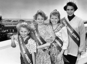 The Clacton Carnival Queen poses with her Princesses in front of the pier, Clacton-on-Sea, UK, 1991