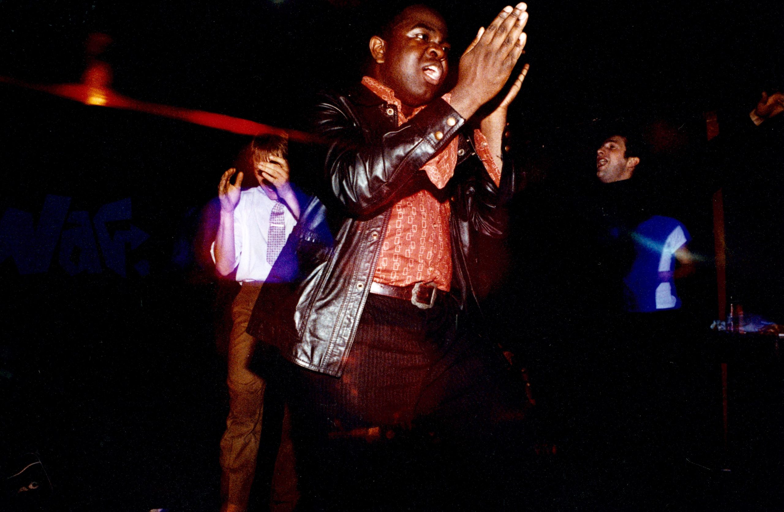 Young man clapping and dancing at a club. Young man clapping and dancing at a club.