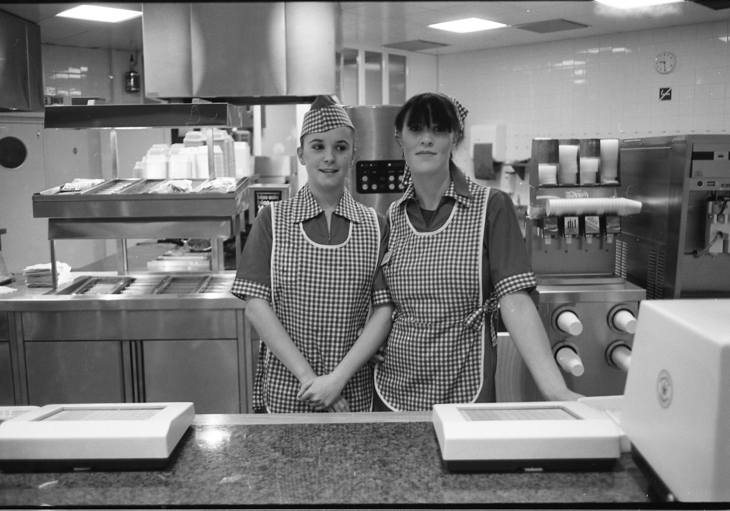 Gavin-Watson-fast-food Two young women in fast food uniform, High Wycombe, UK, 1980s by Gavin Watson